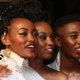 Rafiki stars Sheila Munyiva (left) and Samantha Mugatsia (right) standing with director Wanuri Kahiu at Cannes.
